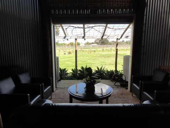 View of the shed corridor from the back area, sofas and armchairs in the foreground.